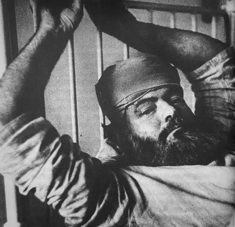 Hemingway in a hospital bed after party with Robert Capa