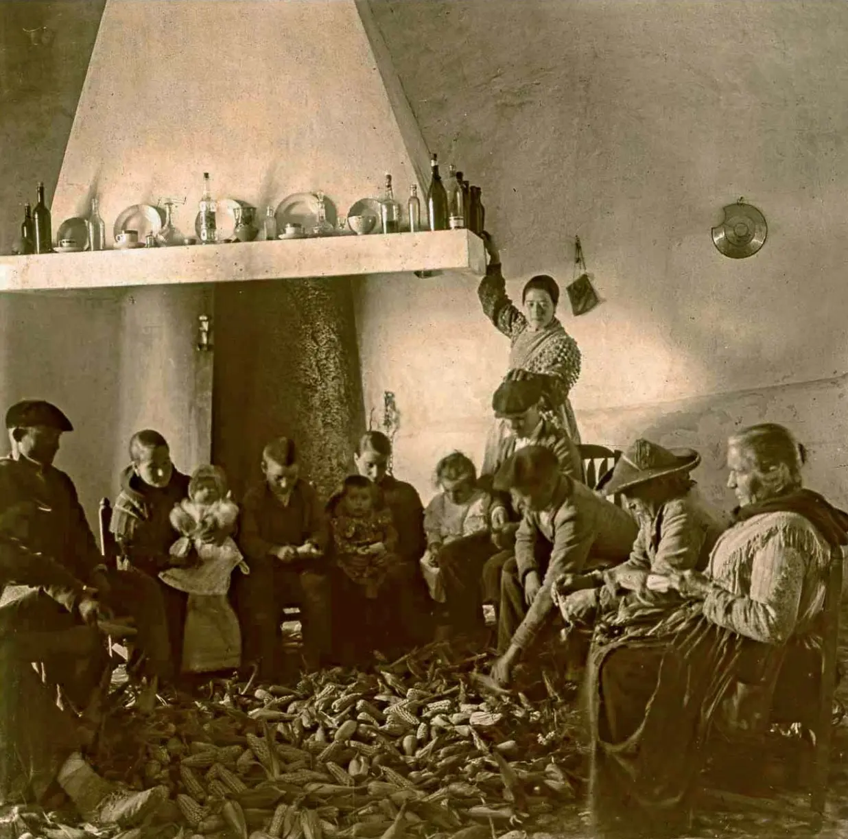 Familia mondando las mazorcas de maíz.