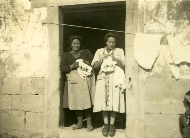 Dos mujeres en la puerta de casa.