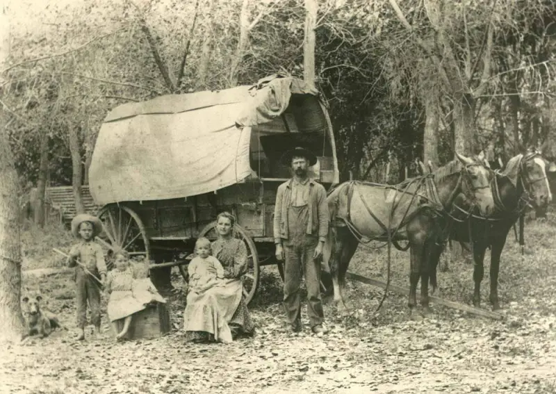 A family with their covered wagon.