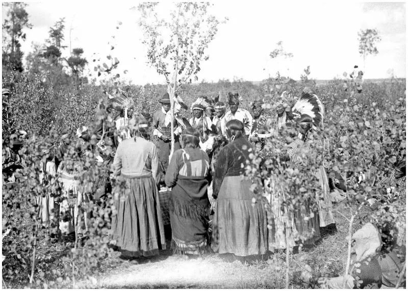 Cree men, women and children participating in a ceremony