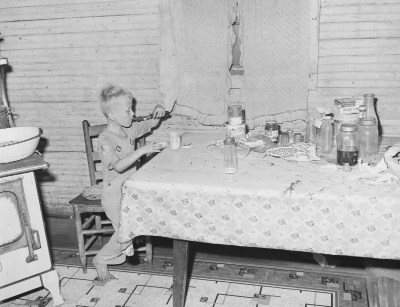 Son of a miner eating in the kitchen 