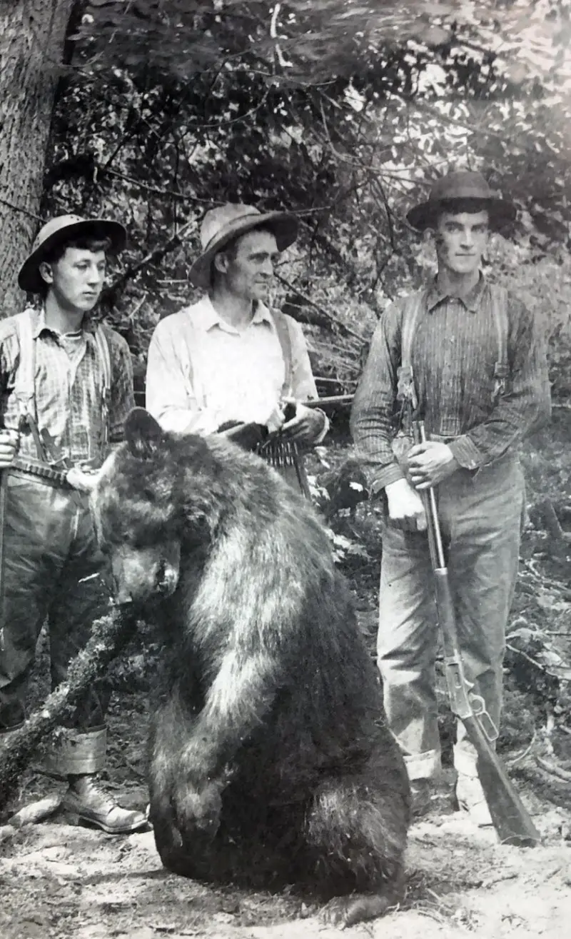 Three hunters pose with their trophy